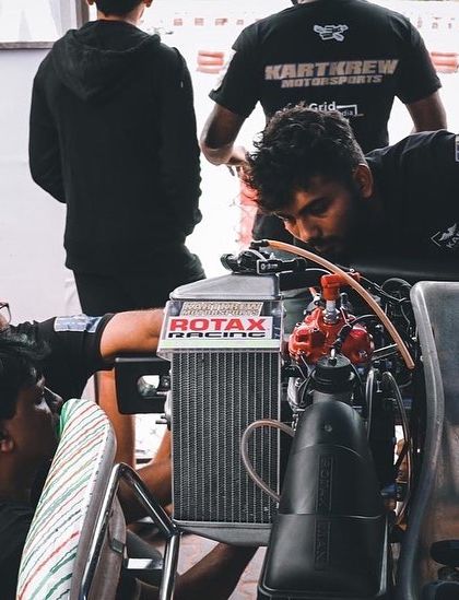 Our mechanics working on a kart's engine in the pit garage.