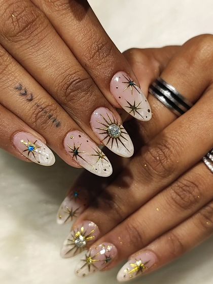 A different angle of the celestial starburst nails, showing the blue and clear rhinestones.