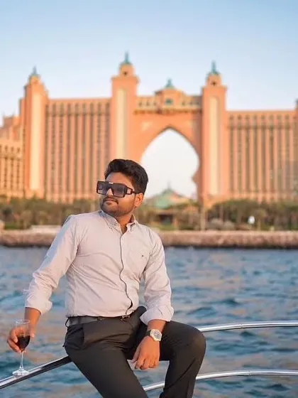 The groom enjoying a moment of quiet confidence on a yacht in Dubai. The iconic Atlantis hotel in the background makes this a truly luxurious and memorable shot.