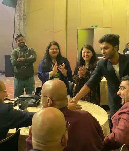 Shaking hands after a successful mind-reading demonstration at a corporate table. The blend of astonishment and laughter is a hallmark of my close-up performances.