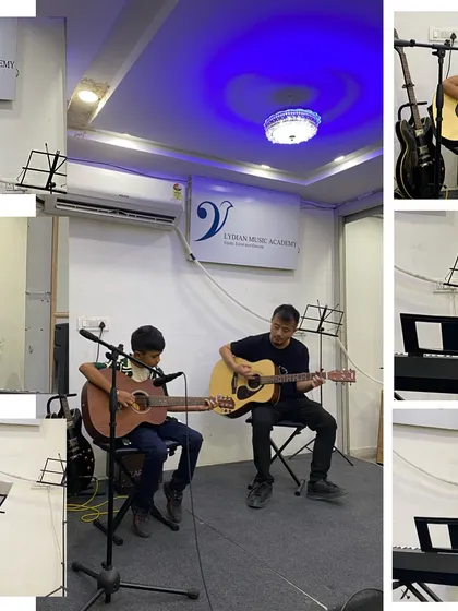 A guitar student performs a duet with his instructor. Our teachers often accompany students to provide support and guidance during their first performances.