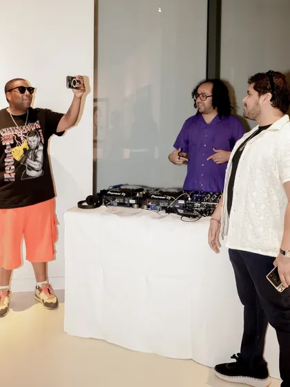 A duplicate of image 107, showing the interaction at the DJ booth.