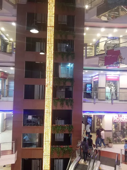A full view of the mall's central elevator shaft, decorated with our artificial greenery on multiple levels.