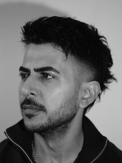 A black and white portrait that captures the bold attitude of the modern mullet haircut.