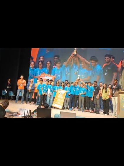 A triumphant moment as one of our winning teams holds their trophy high on stage at the FTC regional championship.