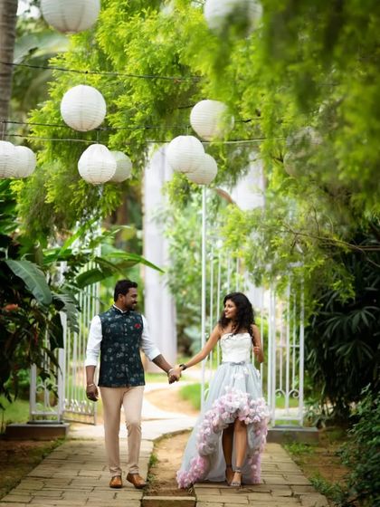 A romantic walk through a lantern-lit path. This couple's outfits are perfect for a dreamy and elegant pre-wedding photoshoot.