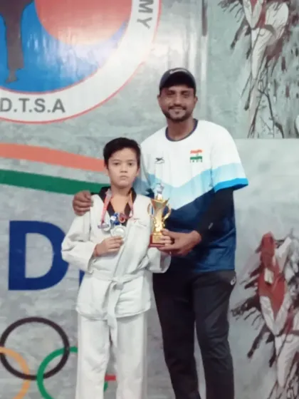 Posing with a silver medalist from my team. Every medal, whether gold, silver, or bronze, is a mark of courage and effort.