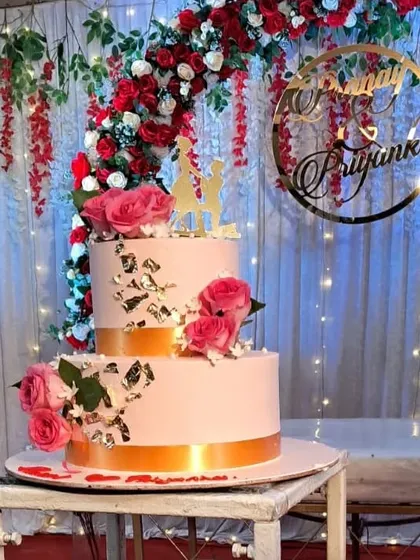 The engagement cake perfectly complements the red and white decor theme. We ensure every element on the stage looks coordinated.