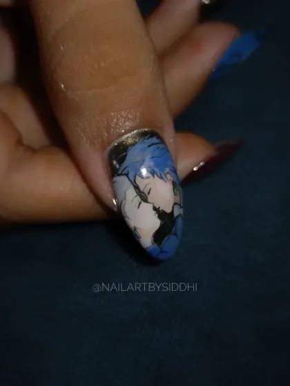 A close-up of a nail from a "Howl's Moving Castle" set, showing the iconic kissing scene hand-painted with incredible detail.