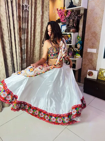 A twirling shot of the white satin lehenga, capturing the movement and grace of the outfit.