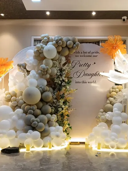 "With a lot of pride, we welcome our Pretty Daughter into this world." This elegant welcome party decor features a neutral color palette with pops of orange and beautiful butterfly details.