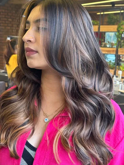 This still shot captures the intricate details of a multi-tonal balayage. You can see the different shades of ash and caramel weaving through the hair, creating a rich tapestry of color.