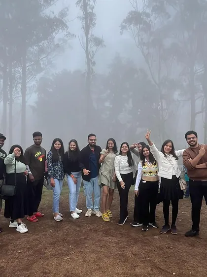 The fog adds a magical atmosphere to our group photos in the Kodaikanal forest.