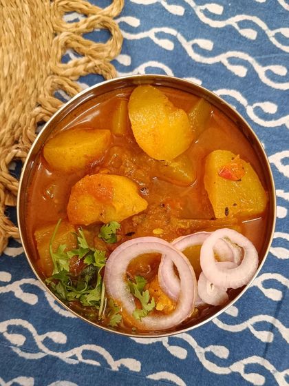 A closer view of the Aloo Lauki sabzi, showing the soft-cooked vegetables in a mild, flavorful gravy.
