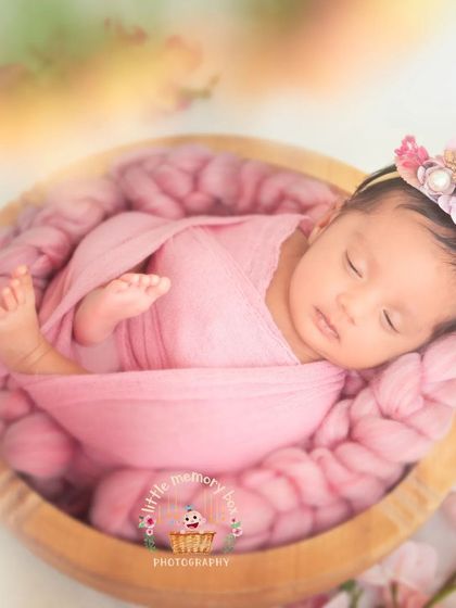 A closer view of this sweet baby, showing their tiny feet peeking out. Capturing these little details is so important in newborn photography.