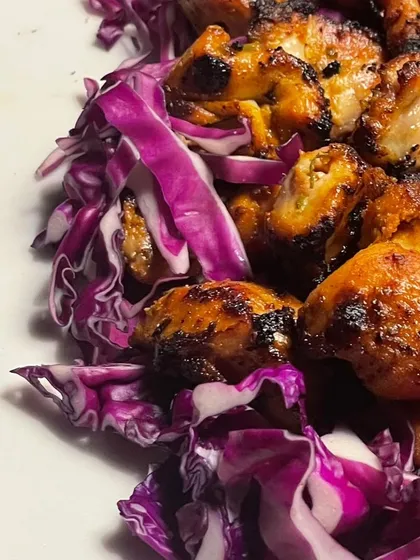 A close-up of the grilled chicken, showing the beautiful char and seasoning. I ensure every piece is cooked perfectly to remain juicy and tender.