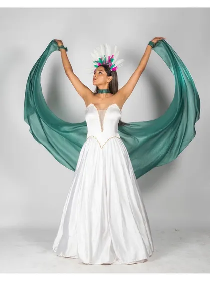 A dramatic, full-length pose where the model uses the flowing green fabric to create a wing-like shape. This shot adds a touch of theatricality and movement, perfect for an avant-garde fashion concept.