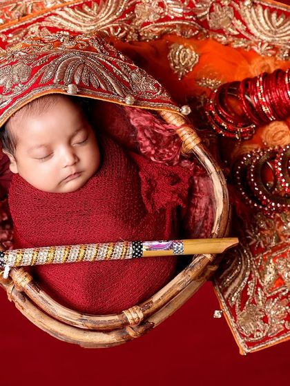 New beginnings surrounded by the essence of heritage. This traditional setup, with its rich red fabric and cultural elements, is a beautiful way to honor your family's roots.