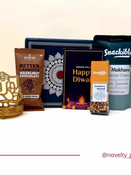 This hamper combines blessings and treats. It features a beautiful Ganesha-themed candle holder, assorted healthy snacks, and a Diwali card, all packed in an elegant box. A thoughtful gift for the festive season.