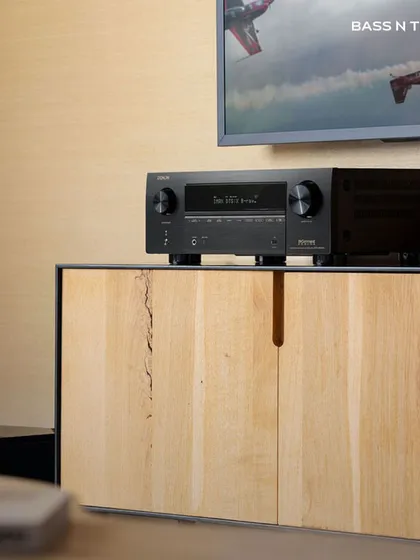 This lifestyle shot shows a Denon receiver as part of a clean, modern living room theatre. Our systems are designed to integrate seamlessly into your home and your life.