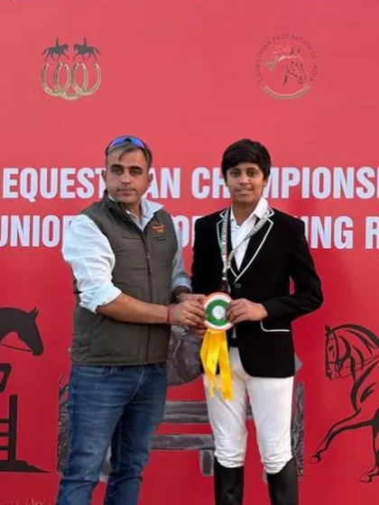 A young rider receives his ribbon for a 2nd place finish in National Eventing. We are there to support our riders every step of the way.