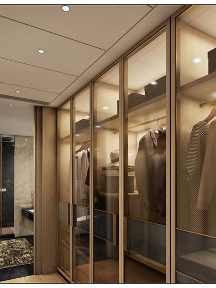 A well-organized and stylish walk-in closet is essential for a serene bedroom. This design features glass-paneled doors and integrated lighting to showcase the wardrobe, combining functionality with a touch of luxury.