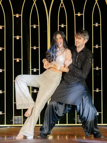 A fun and playful pose from the star couple's performance. We work with you to choreograph numbers that reflect your personality, whether it's romantic, fun, or a mix of both.