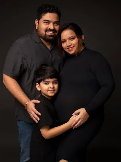 The same family in a full-color classic portrait. The rich, dark background makes their connection and happiness stand out, creating a powerful family heirloom.