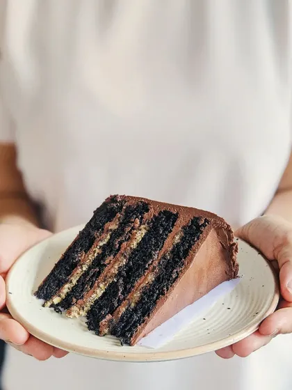 While the outside is what you see first, what's inside is just as important to me. This is a slice of my heirloom chocolate cake, a recipe passed down through generations, showing the rich layers that make every bite memorable.