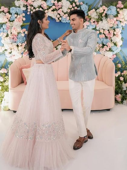 Another shot of the couple dancing, surrounded by a field of pastel flowers. The soft, dreamy lighting and decor create a perfect atmosphere for celebrating their love.