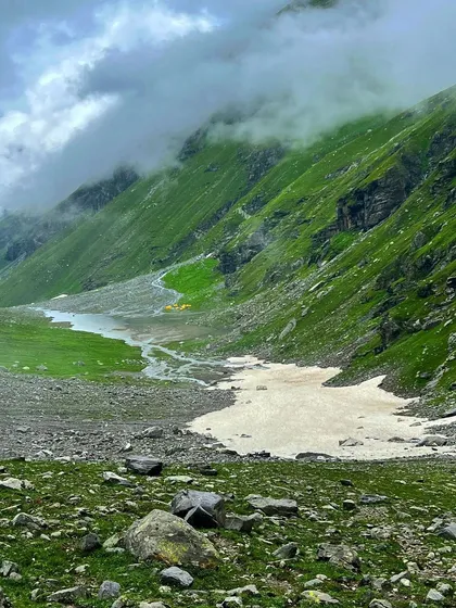 A view of the Hampta Pass trail, with a patch of snow even in September, showing the high-altitude nature of the trek.