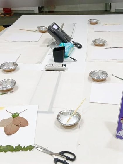 An "Art of Nature" workshop set up in an office space. We bring all the supplies, from leaves and twigs to paper and glue, for a creative session where kids make art from natural materials.