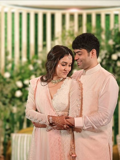 A sweet, candid moment between the newly engaged couple, sharing a hug and a smile.