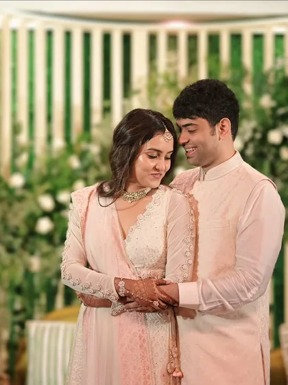 A sweet, candid moment between the newly engaged couple, sharing a hug and a smile.