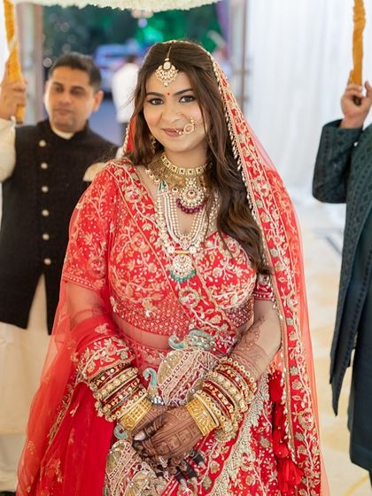 The bride's entrance, looking serene and beautiful. Her makeup is designed to photograph beautifully, capturing her glow in every shot.