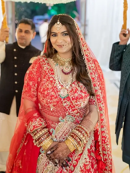 The bride's entrance, looking serene and beautiful. Her makeup is designed to photograph beautifully, capturing her glow in every shot.
