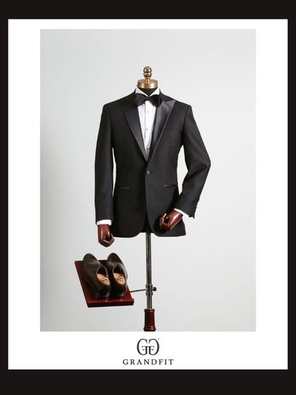 Our standard for excellence is visible in every piece. This tuxedo, displayed with formal shoes, represents a complete, ready-to-wear vision of sartorial perfection.