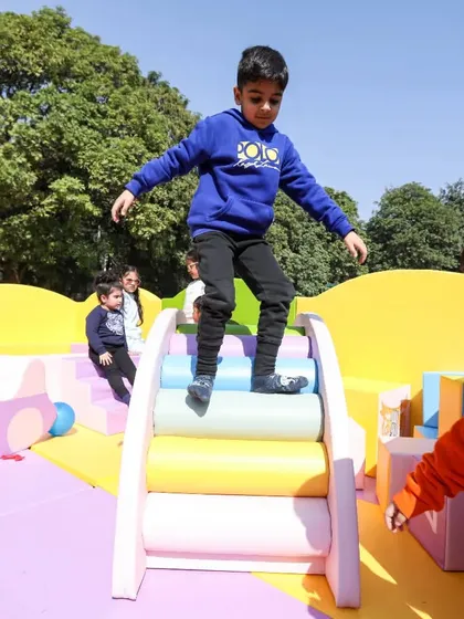 A moment of pure freedom and fun as a child jumps from the top of our soft rainbow climber.
