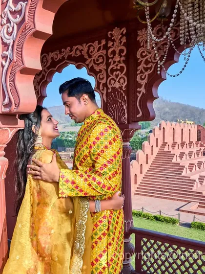 An intimate portrait framed by the ornate arches of our palace set, with the stepwell visible in the background, showcasing the variety within a single location.