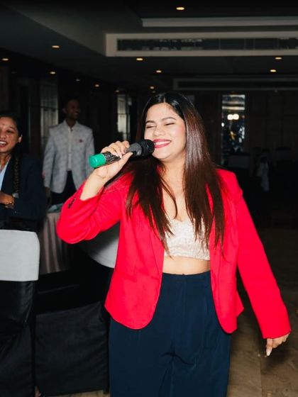 A joyful shot of me singing and interacting with the audience at their tables during the Skills Bazzar event.