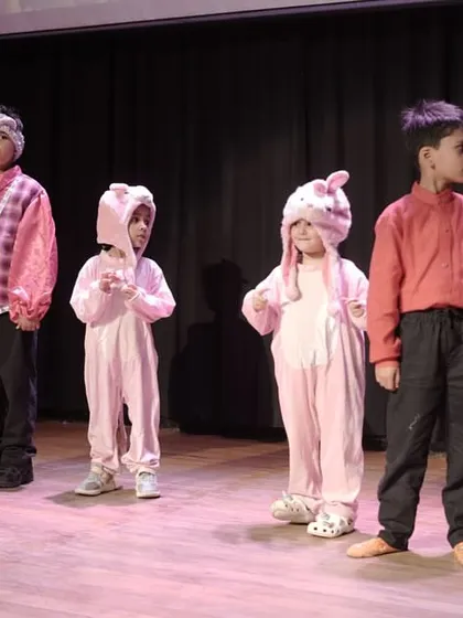 Our youngest actors, dressed as pigs, showing great stage discipline and character embodiment. Even in non-speaking roles, presence and physicality are key.