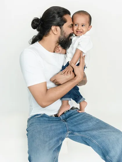 The bond between a father and his child is filled with such unique playfulness and warmth. I love capturing these candid interactions, where a simple cuddle turns into a memory filled with laughter.