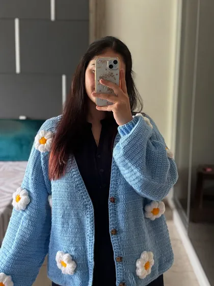 Here is the sky blue version of our Moonlight Cardigan. The bright color and cheerful daisies make it a standout piece, perfect for adding a bit of fun to your wardrobe.