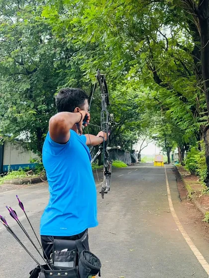 A closer view of our coach at full draw, demonstrating the proper technique for long-distance shooting.