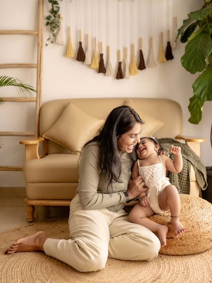 A mother and daughter playing on the floor, both full of laughter. These are the moments to remember.