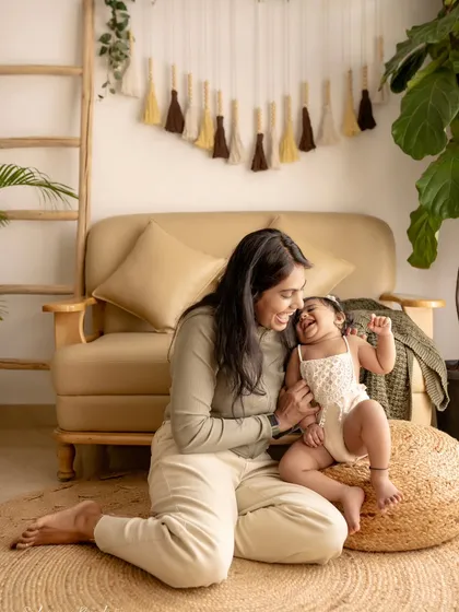 A mother and daughter playing on the floor, both full of laughter. These are the moments to remember.