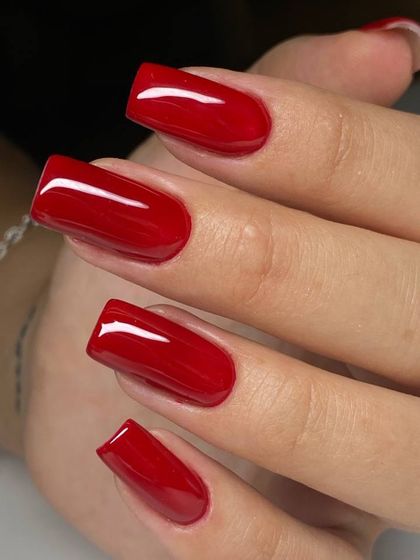 A bold, classic red on perfectly sculpted square extensions. The flawless application and glossy finish highlight the quality of our work.
