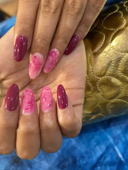 Here's a closer look at my hand-painted marble art. I used shades of pink and magenta on long almond-shaped extensions to create this beautiful, stone-like effect. Each nail is unique, just like real marble.