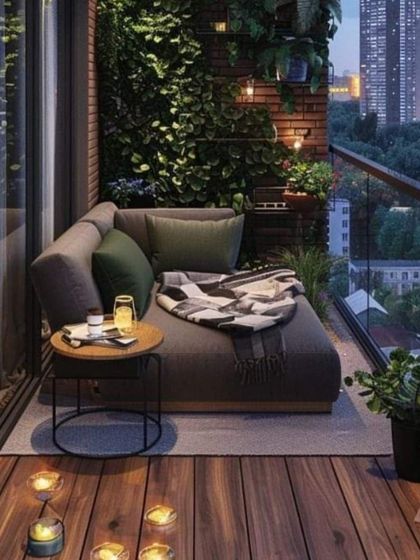A modern and minimalist balcony design featuring a comfortable daybed, a vertical garden for privacy and greenery, and a simple side table. This is urban outdoor living at its most comfortable.