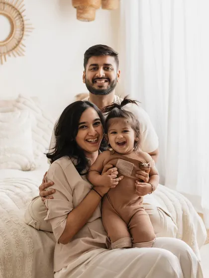 This is what pure joy looks like! I love capturing these candid, laughing moments during my family lifestyle sessions. This photo, taken in my boho-themed studio setup, shows how fun and relaxed a family photoshoot can be.